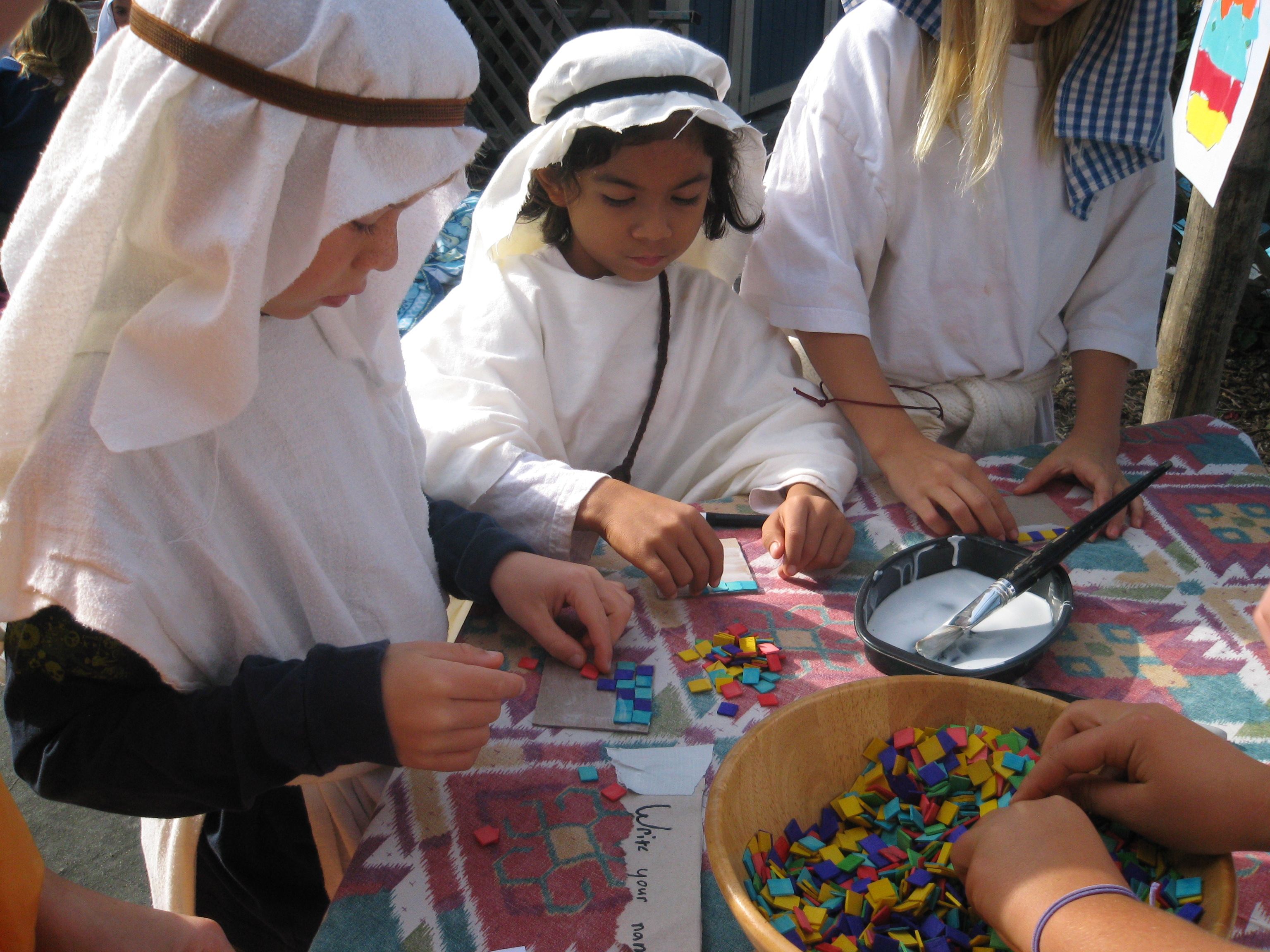 Students dressed as Ancient Sumerians making mosaics 